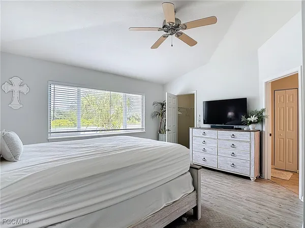 a bedroom with a large bed and a chandelier