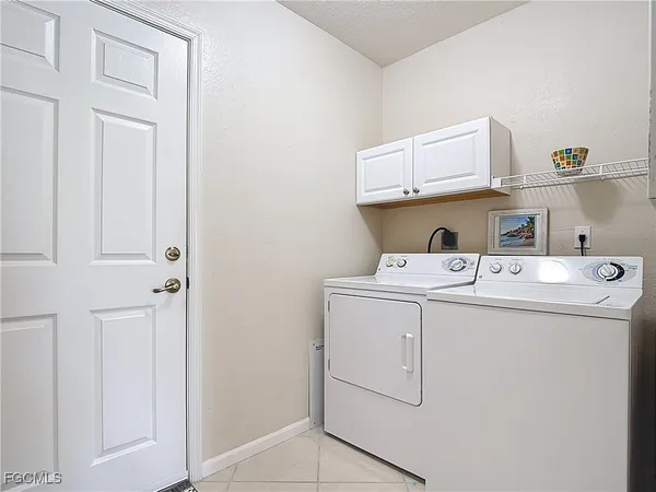 a view of storage and utility room with washer and dryer