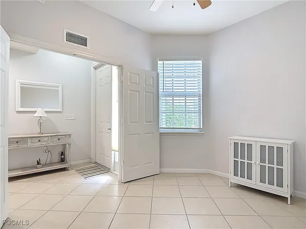 a large white kitchen with a stove a sink a microwave oven and a dining table with wooden floor