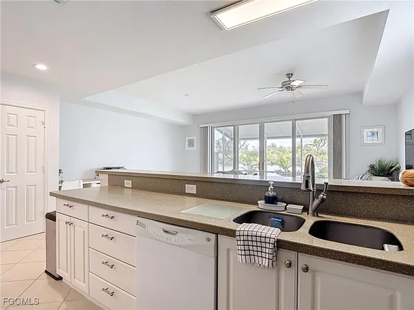 a view of kitchen with stainless steel appliances granite countertop a stove and a refrigerator
