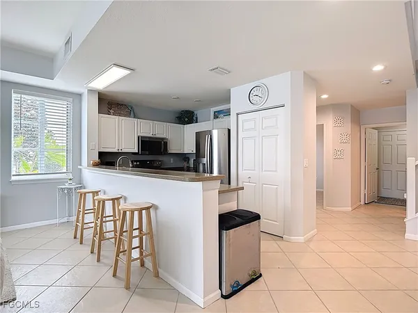 a living room with furniture and a large window with balcony view
