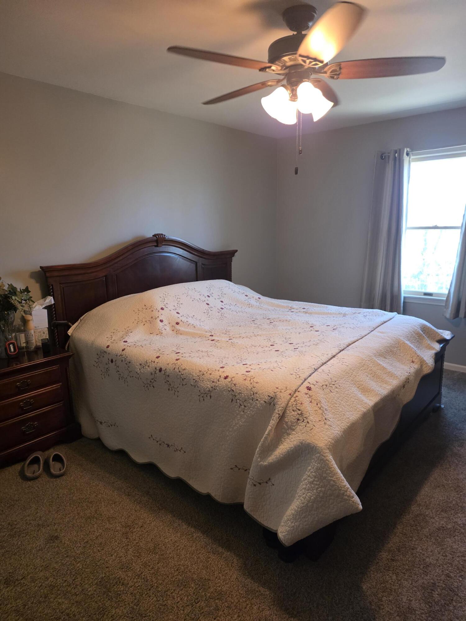 516 Begonia Street Southeast, Unit A De Motte, IN 46310 - Photo 19 of 25 a bedroom with a bed and a chandelier