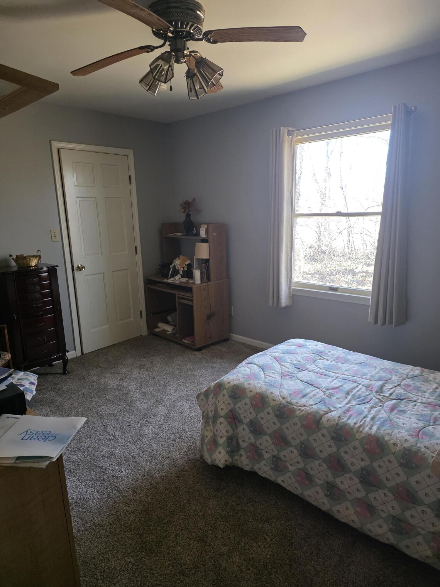 516 Begonia Street Southeast, Unit A De Motte, IN 46310 - Photo 21 of 25 a bedroom with a bed and a chandelier