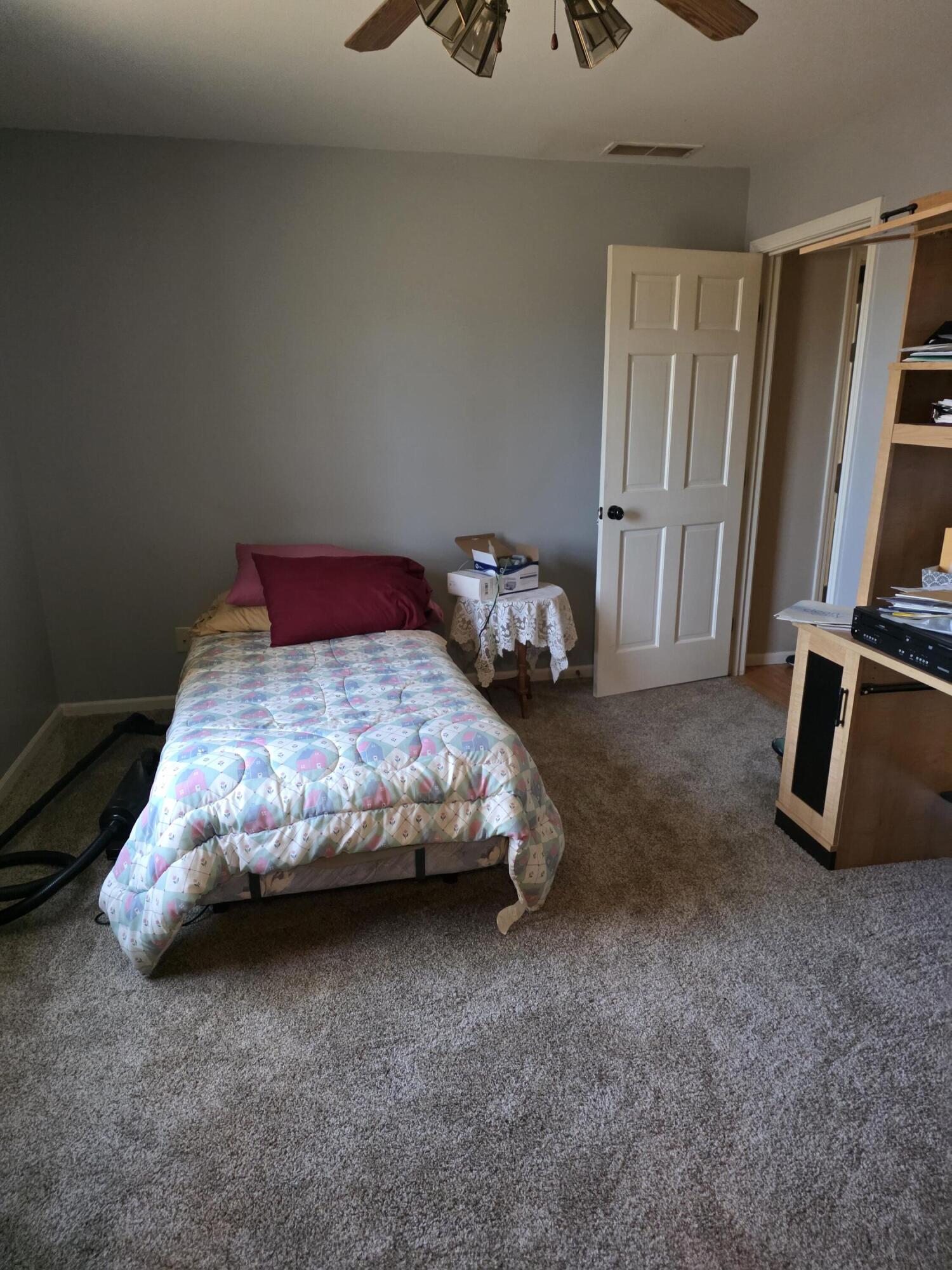 516 Begonia Street Southeast, Unit A De Motte, IN 46310 - Photo 22 of 25 a bedroom with a bed and a flat screen tv