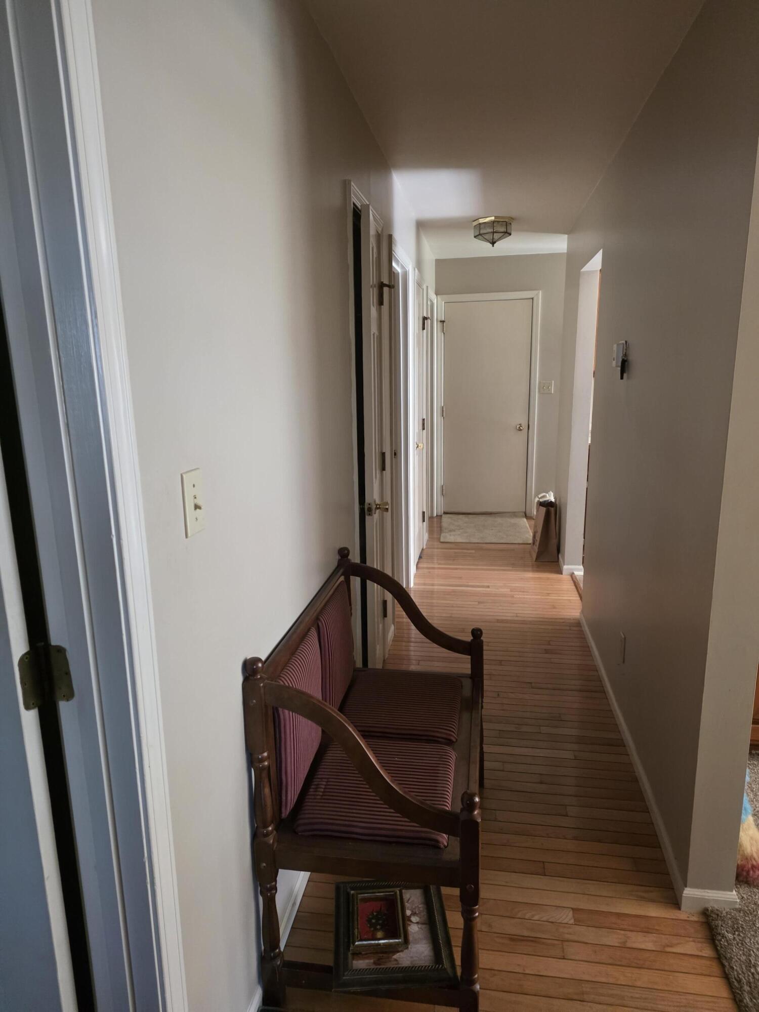 516 Begonia Street Southeast, Unit A De Motte, IN 46310 - Photo 24 of 25 a view of a hallway with wooden floor and staircase