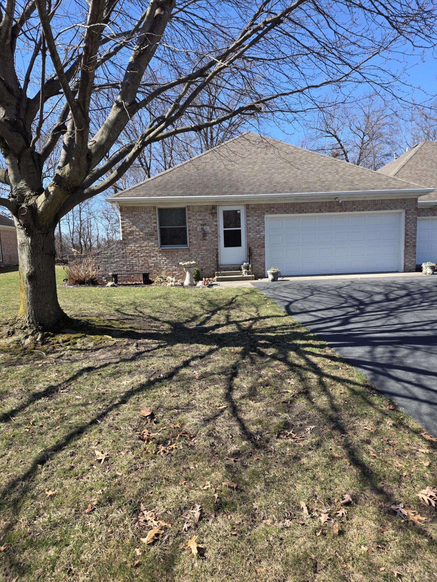516 Begonia Street Southeast, Unit A De Motte, IN 46310 - Photo 3 of 25 a front view of a house with a yard