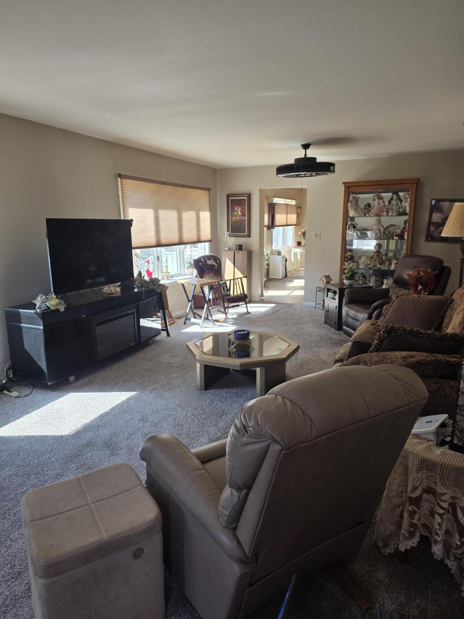516 Begonia Street Southeast, Unit A De Motte, IN 46310 - Photo 4 of 25 a living room with furniture and a flat screen tv
