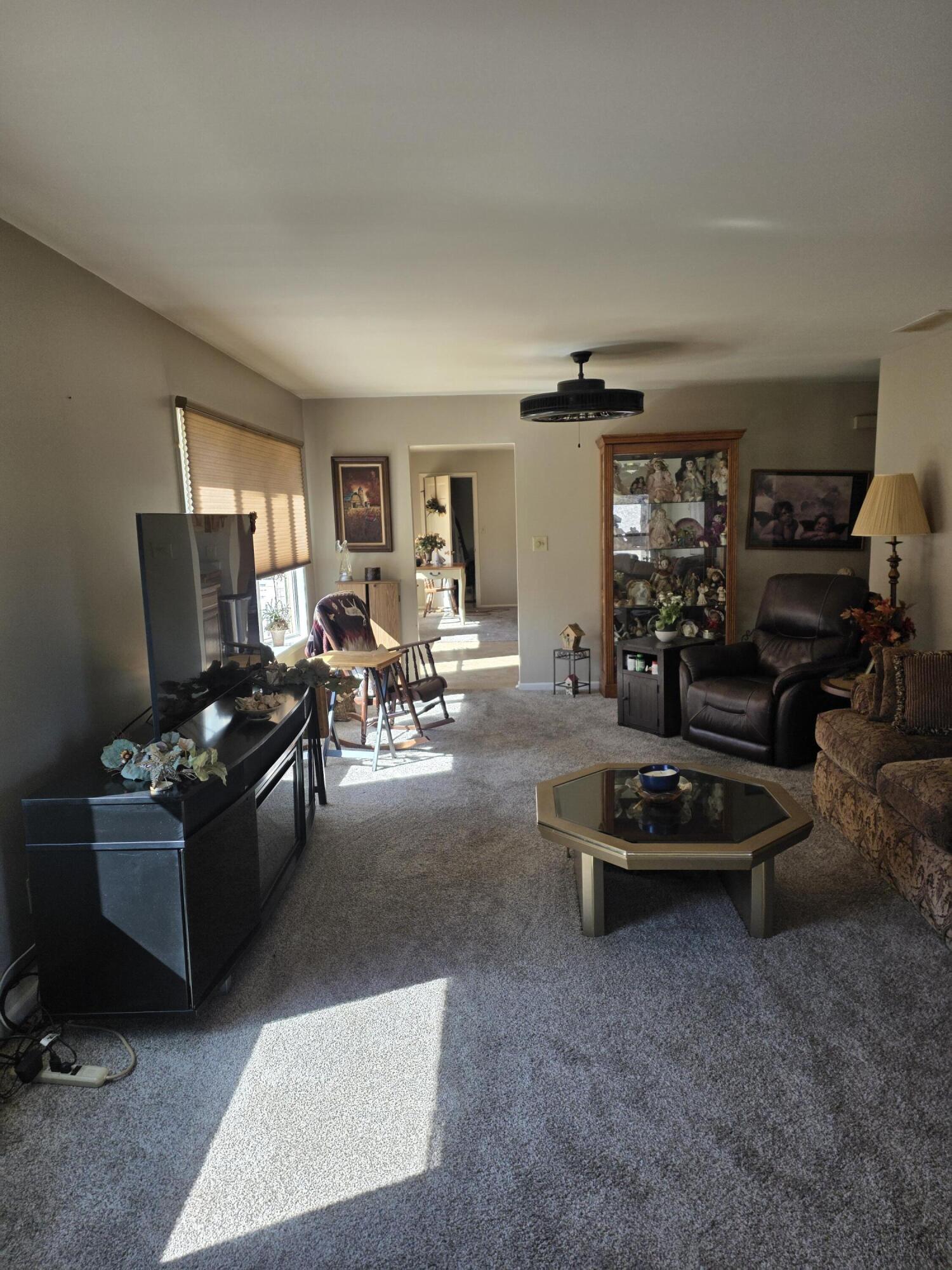 516 Begonia Street Southeast, Unit A De Motte, IN 46310 - Photo 5 of 25 a living room with furniture a window and gym equipment