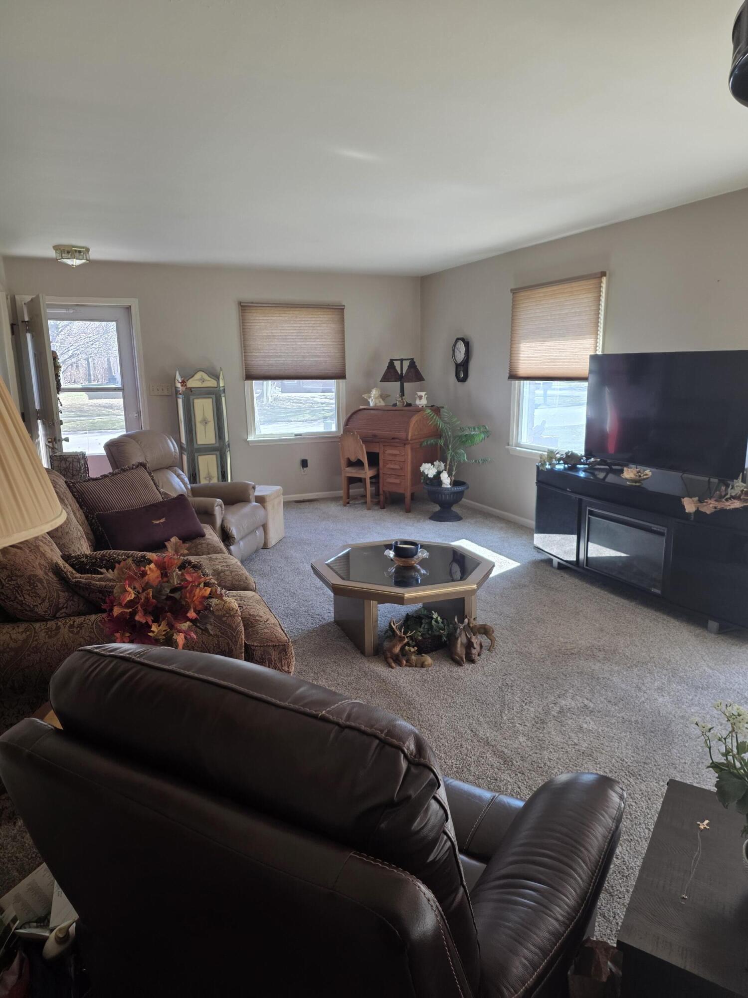 516 Begonia Street Southeast, Unit A De Motte, IN 46310 - Photo 7 of 25 a living room with furniture and a flat screen tv