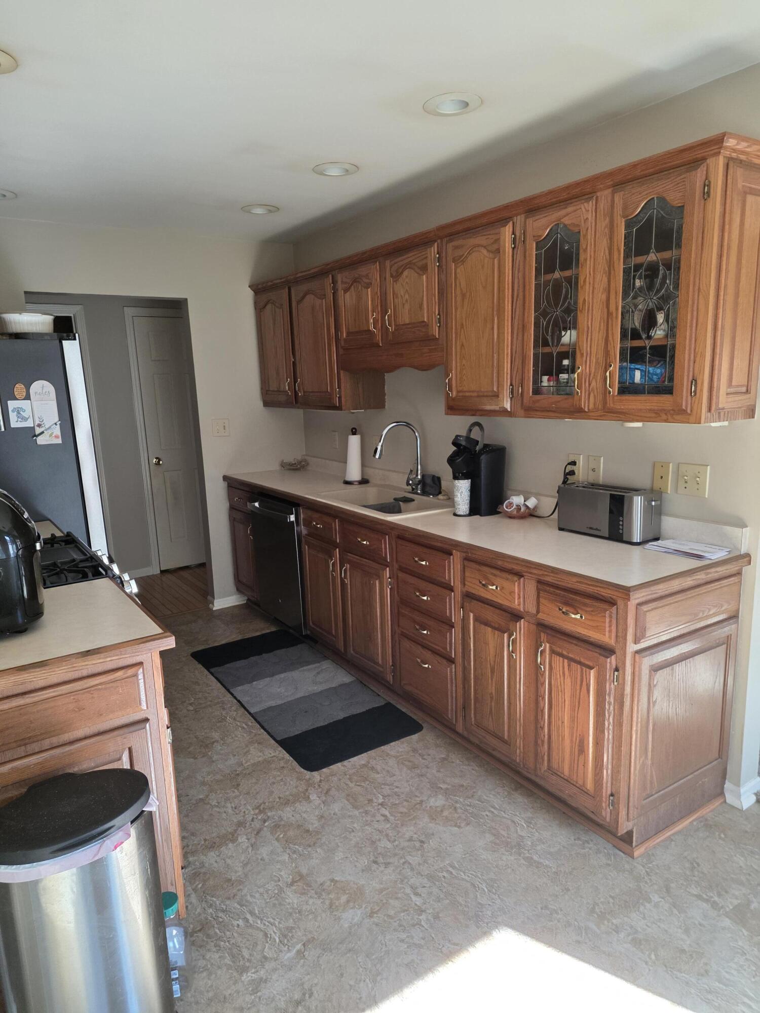 516 Begonia Street Southeast, Unit A De Motte, IN 46310 - Photo 10 of 25 a kitchen with stainless steel appliances granite countertop a sink stove and cabinets