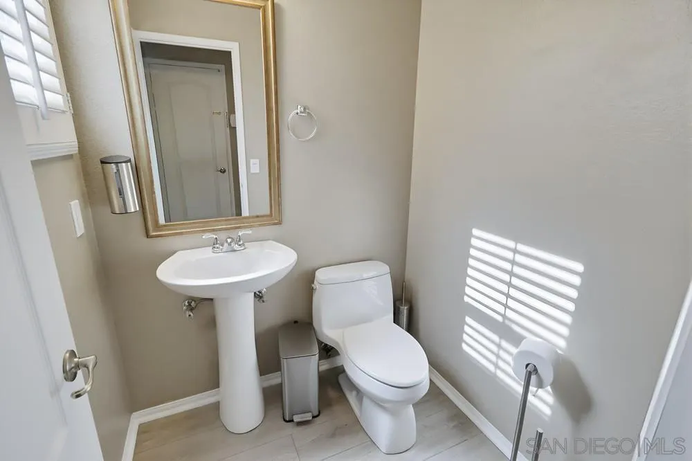 2170 Bobcat Court, Unit 126 Chula Vista, CA 91915 - Photo 12 of 28 a bathroom with a sink toilet and a mirror