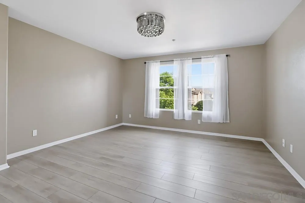 2170 Bobcat Court, Unit 126 Chula Vista, CA 91915 - Photo 16 of 28 a view of an empty room with wooden floor and a window