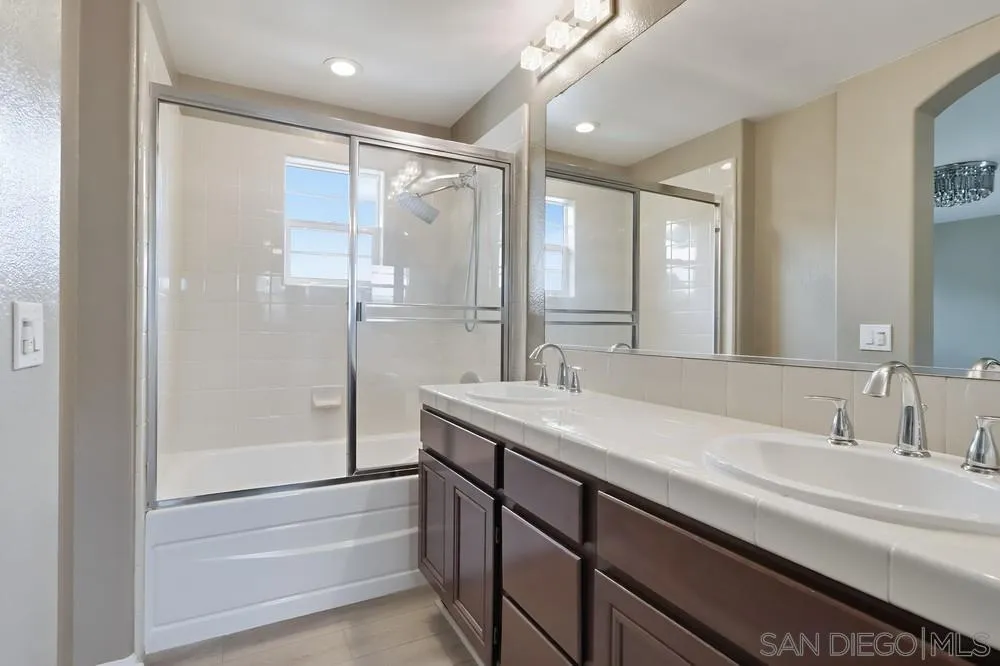 2170 Bobcat Court, Unit 126 Chula Vista, CA 91915 - Photo 18 of 28 a bathroom with a granite countertop sink mirror and double