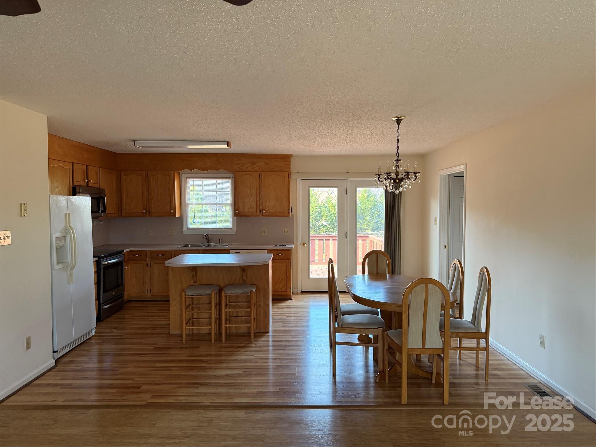 401 Miller Farm Road Statesville, NC 28625 - Photo 3 of 18 a dining room with furniture a chandelier and wooden floor