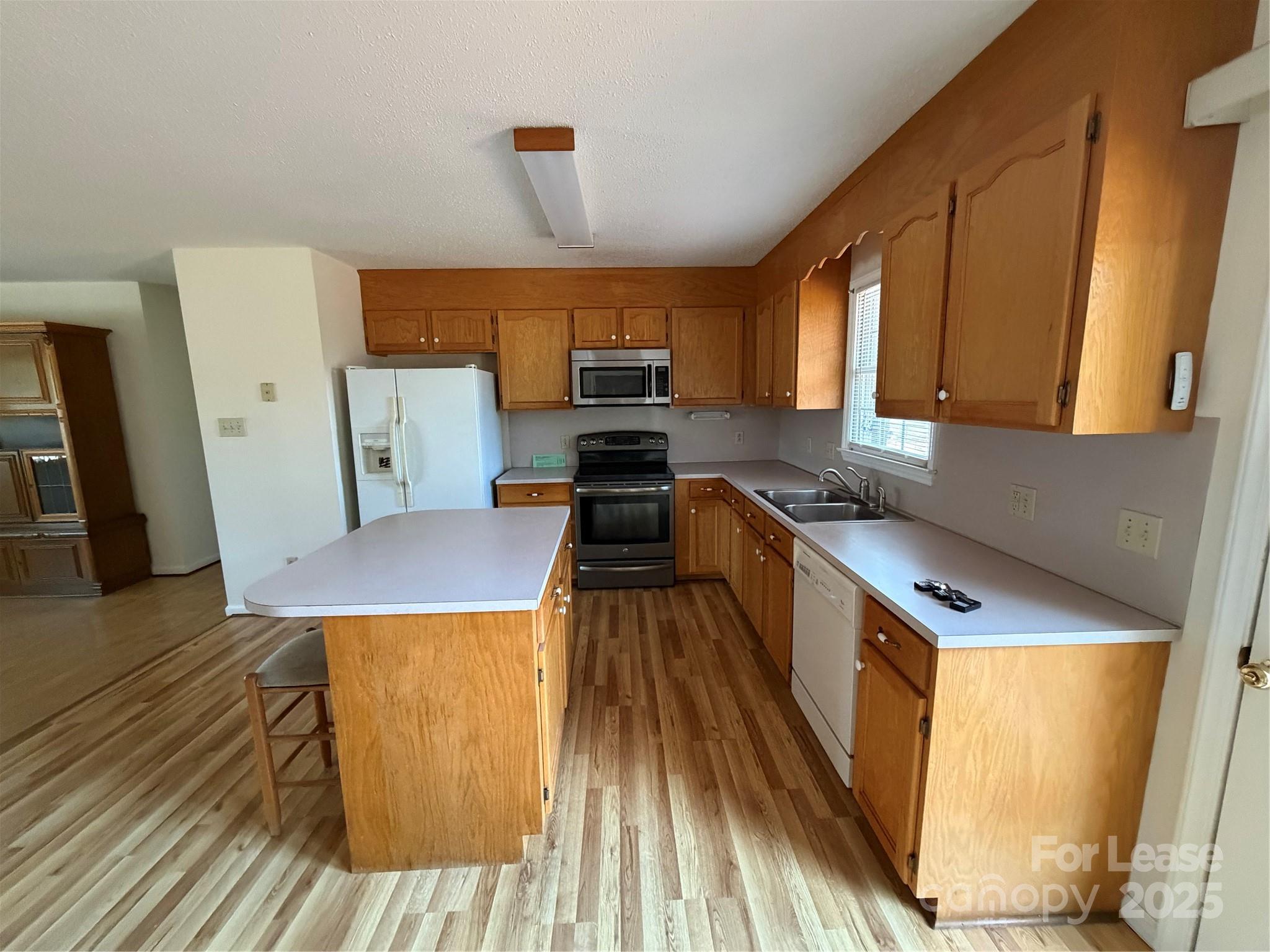 401 Miller Farm Road Statesville, NC 28625 - Photo 4 of 18 a kitchen with counter top space a sink wooden floor and view living room
