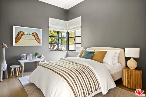 a bedroom with bed and a window