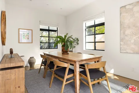 a view of a dining room with furniture and window