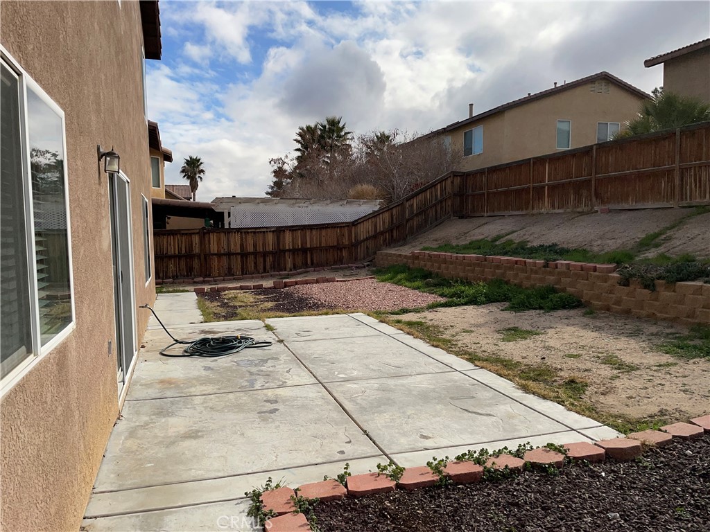 12661 Luna Road Victorville, CA 92392 - Photo 20 of 20 a view of backyard with wheel chair and potted plants