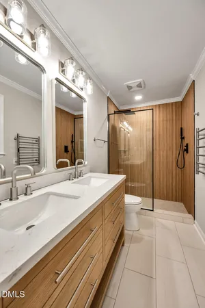 a spacious bathroom with a shower a sink and mirror