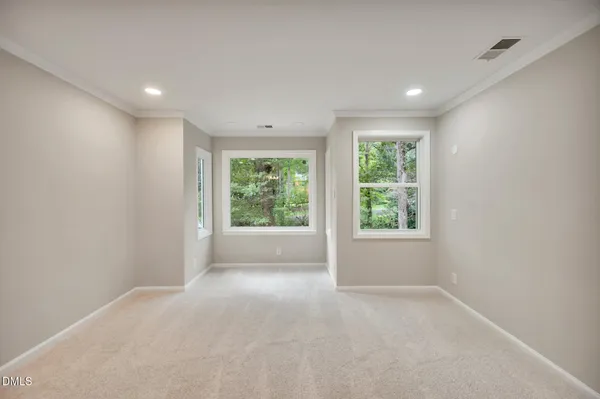 an empty room with windows and yard