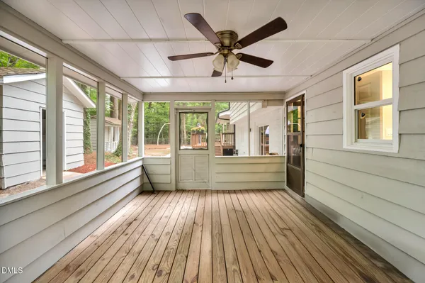 a view of a room with wooden floor and windows