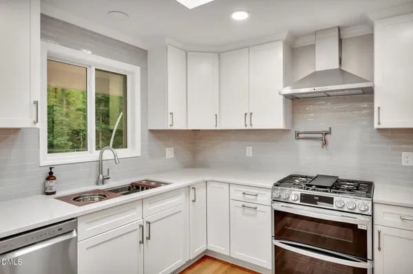 a kitchen with a stove oven and sink