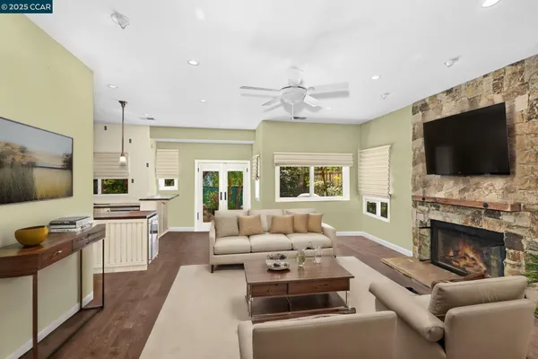 a living room with furniture fireplace and flat screen tv