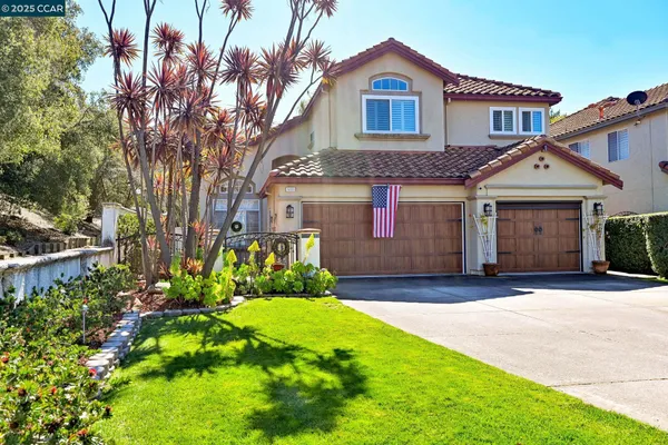 a front view of a house with a yard and garage