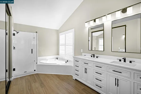 a bathroom with a double vanity sink mirror double and bathtub
