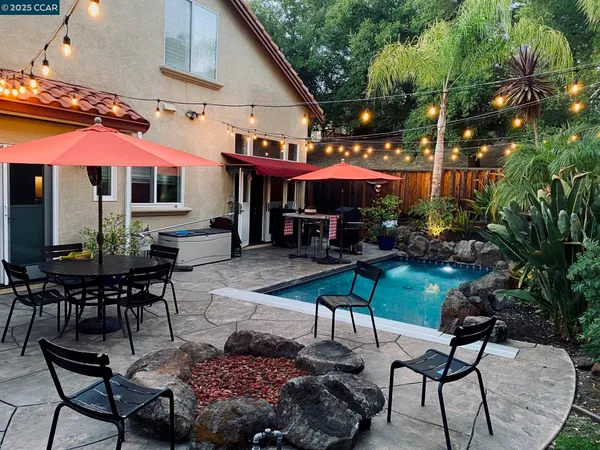 a view of a backyard with plants and lake