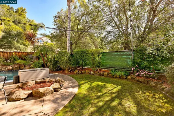 a view of a backyard with sitting area