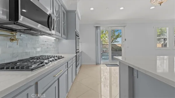a kitchen with stainless steel appliances granite countertop a stove and a refrigerator