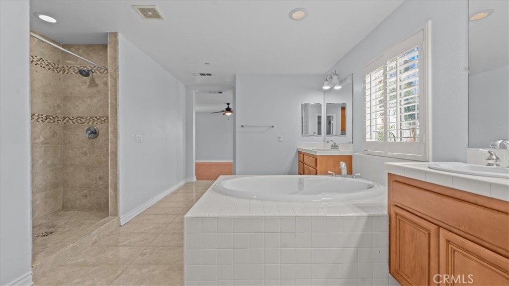 5448 Turin Way Fontana, CA 92336 - Photo 17 of 40 a bathroom with a sink and shower