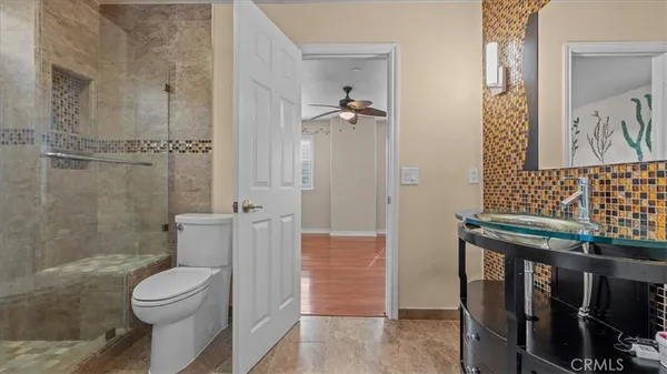 a bathroom with a toilet a sink and shower