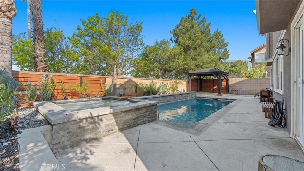 5448 Turin Way Fontana, CA 92336 - Photo 29 of 40 a view of a swimming pool with a patio