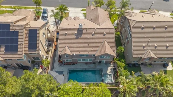 an aerial view of residential houses with outdoor space and parking