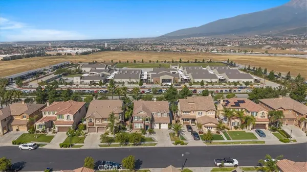 an aerial view of a house with a yard