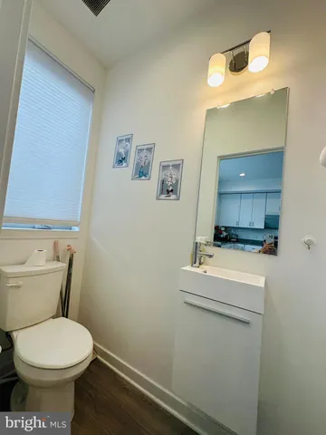 a bathroom with a sink toilet and a mirror