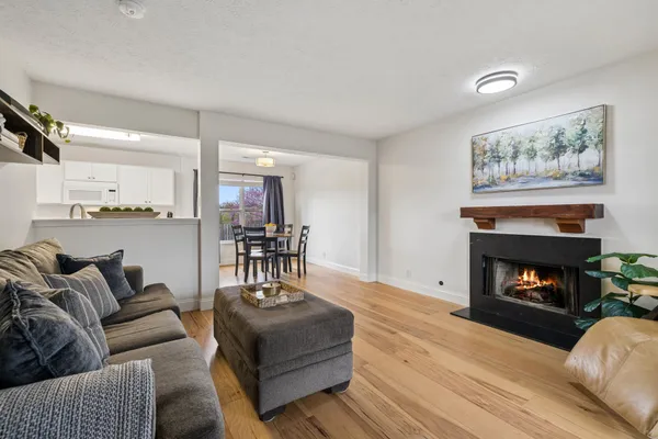 a living room with furniture and a wooden floor