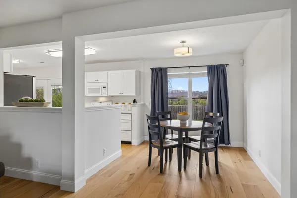 a view of a dining room with furniture and wooden floor