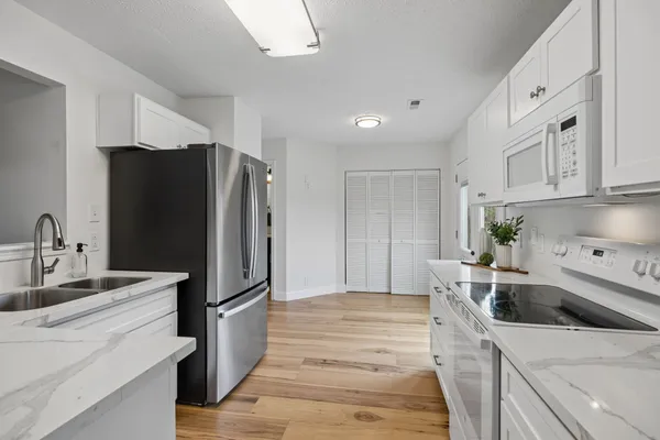 a spacious bedroom with a bed a couch and a flat screen television