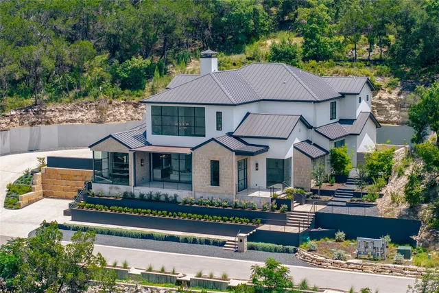 a front view of house with a garden and patio