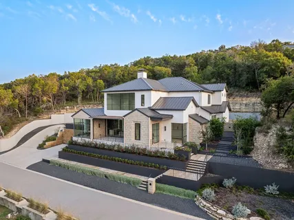 a front view of a house with a garden