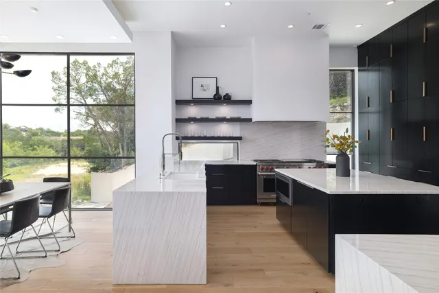 a view of a dining room with furniture water view and a floor to ceiling window