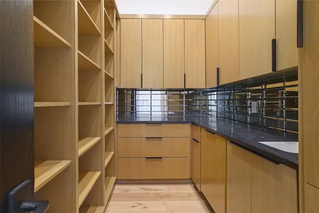 a kitchen with a sink and a large window
