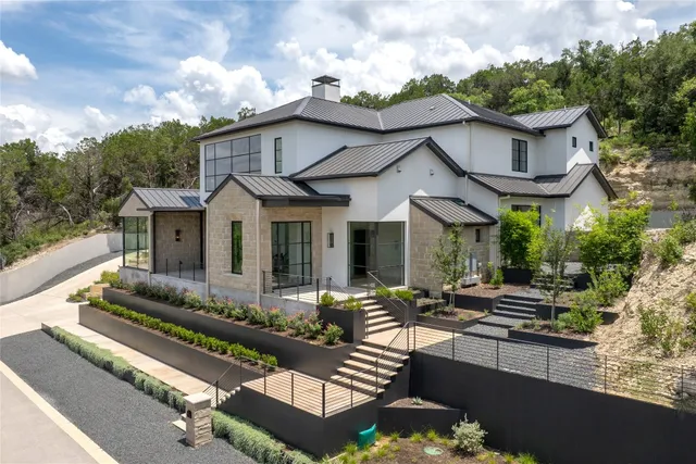 a front view of a house with a garden