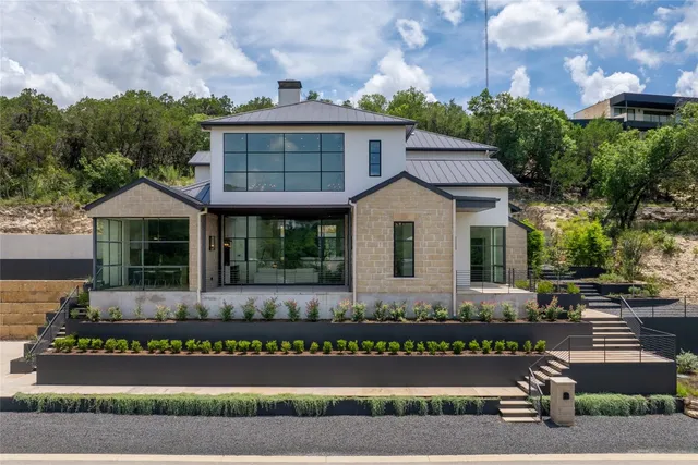 a front view of a house with a garden