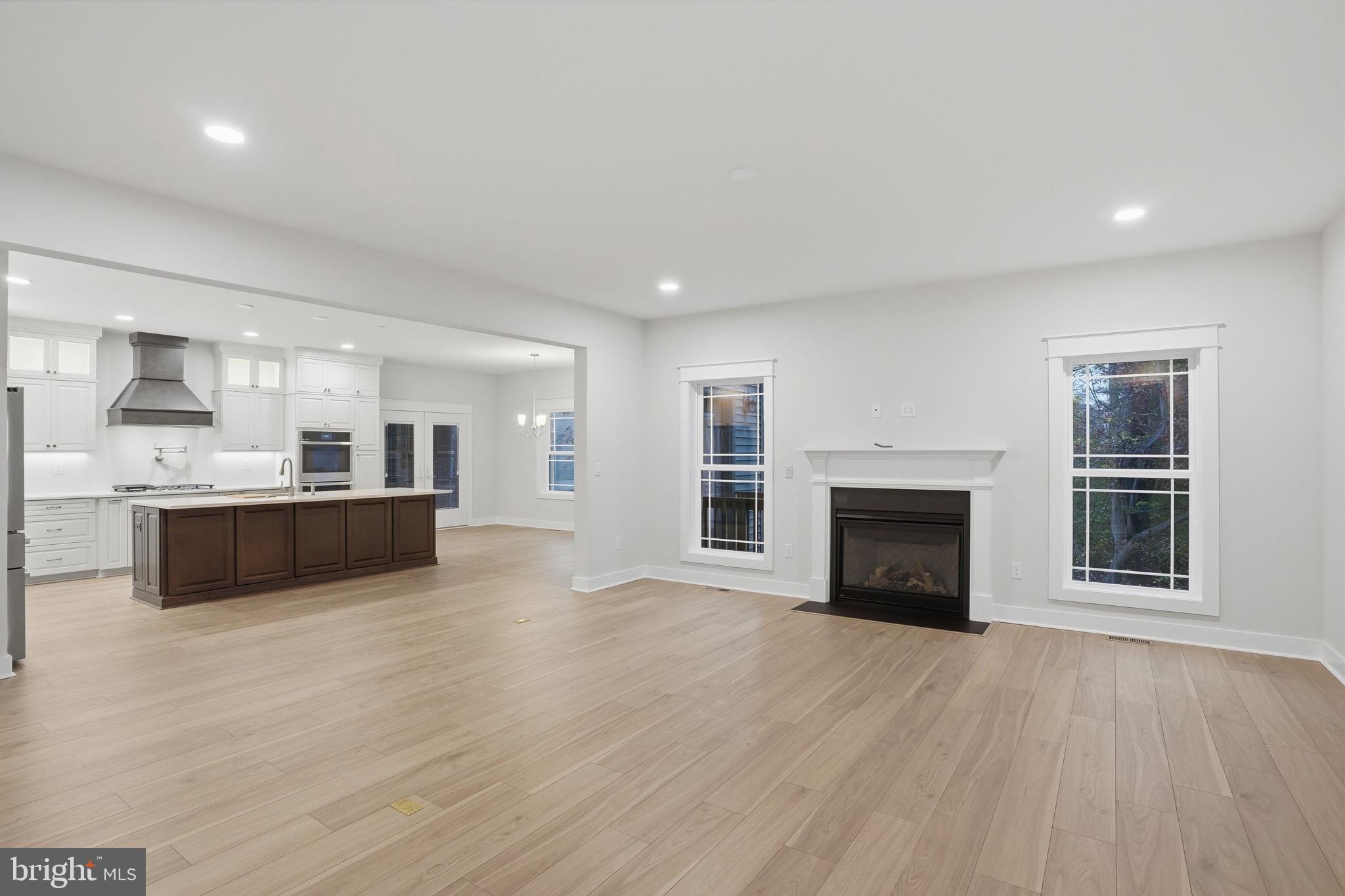 25015 Prairie Lane, Unit 3 Millsboro, DE 19966 - Photo 11 of 42 a large white kitchen with a sink and dishwasher a oven with white cabinets