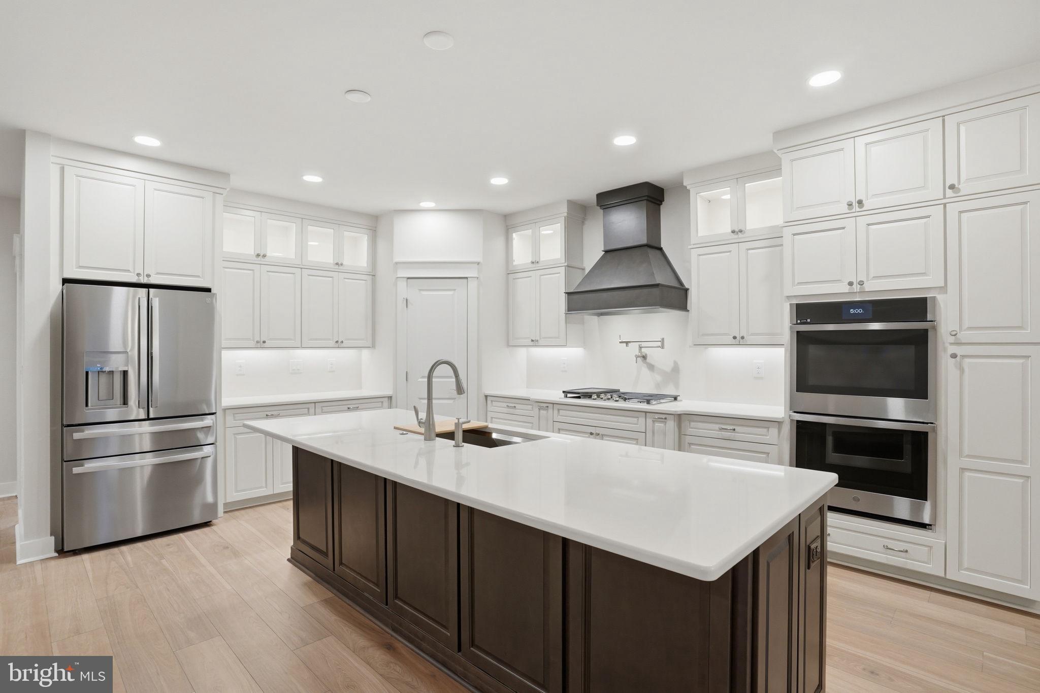 25015 Prairie Lane, Unit 3 Millsboro, DE 19966 - Photo 14 of 42 a kitchen with a sink stainless steel appliances and white cabinets