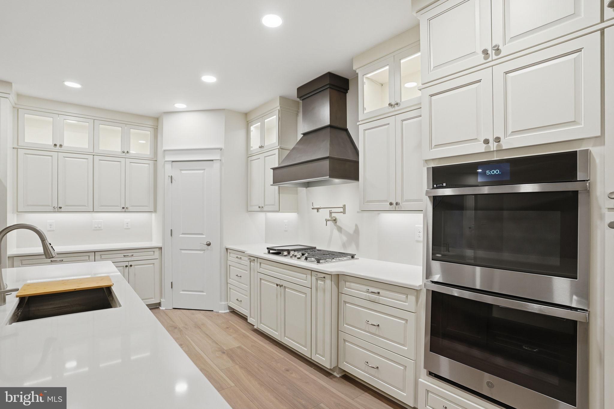 25015 Prairie Lane, Unit 3 Millsboro, DE 19966 - Photo 16 of 42 a kitchen with white cabinets and appliances
